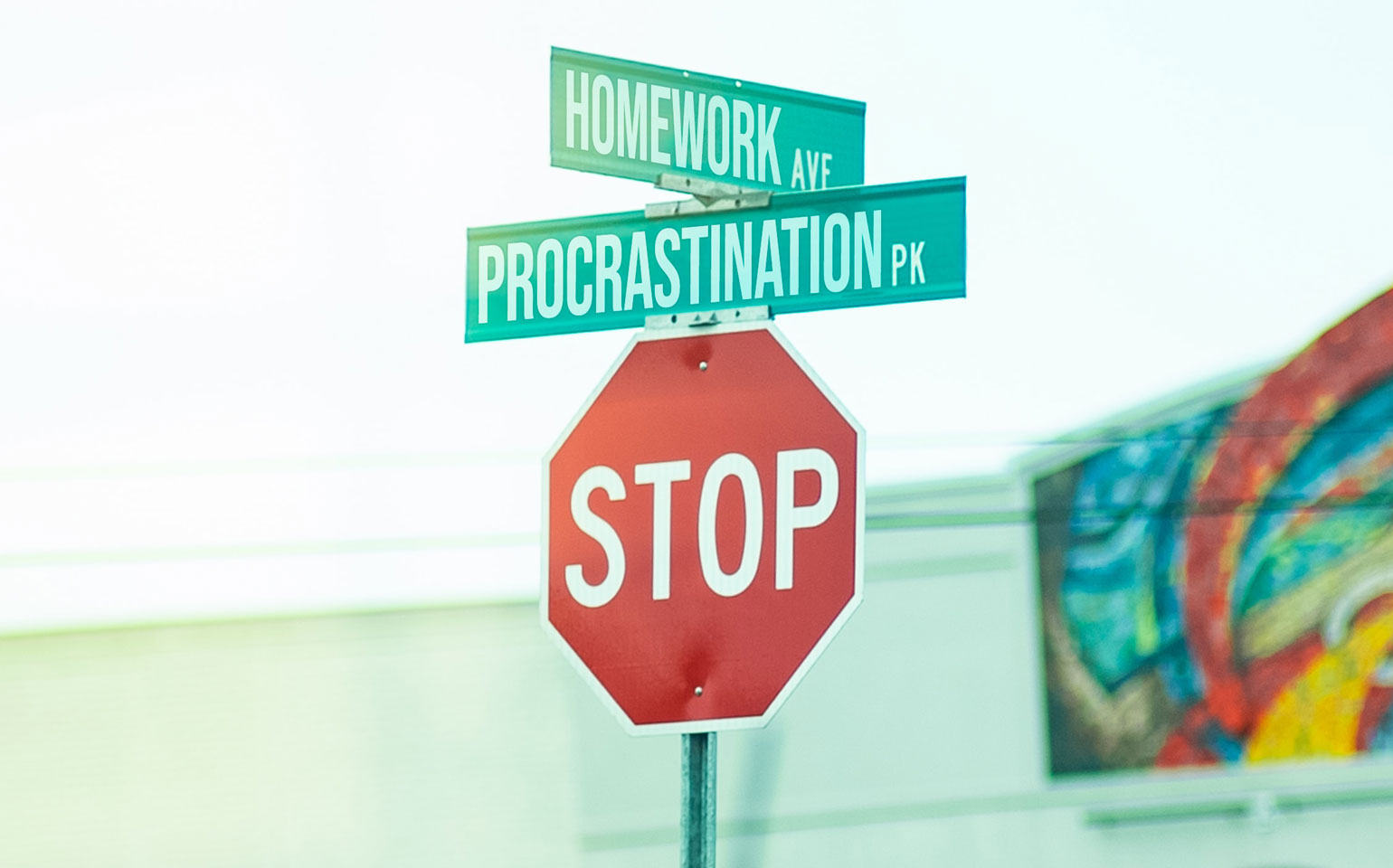 Homework Ave and Procrastination Pk road sign sitting on a stop sign.