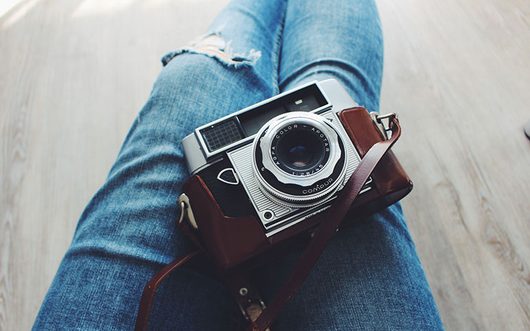 Old camera sitting on a person's lap