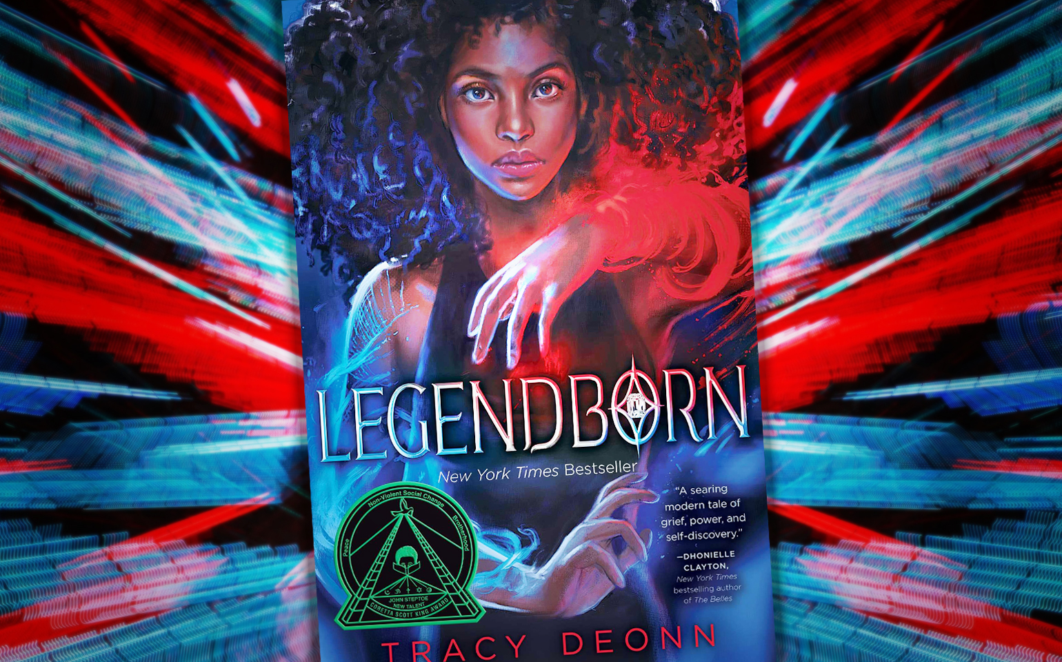 The cover of Tracy Deonn's Legendborn is shown, with a woman's glowing arm appearing in full view.