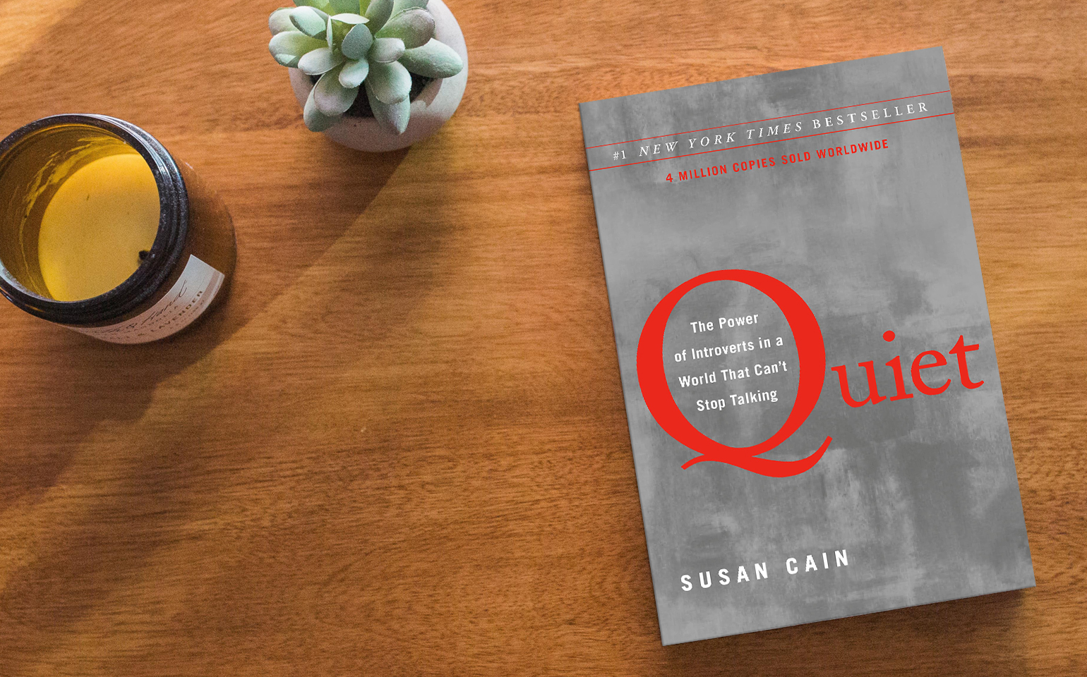 The cover of Susan Cain's Quiet is shown, which features a large "Q" against a cloudy and calm sky background.