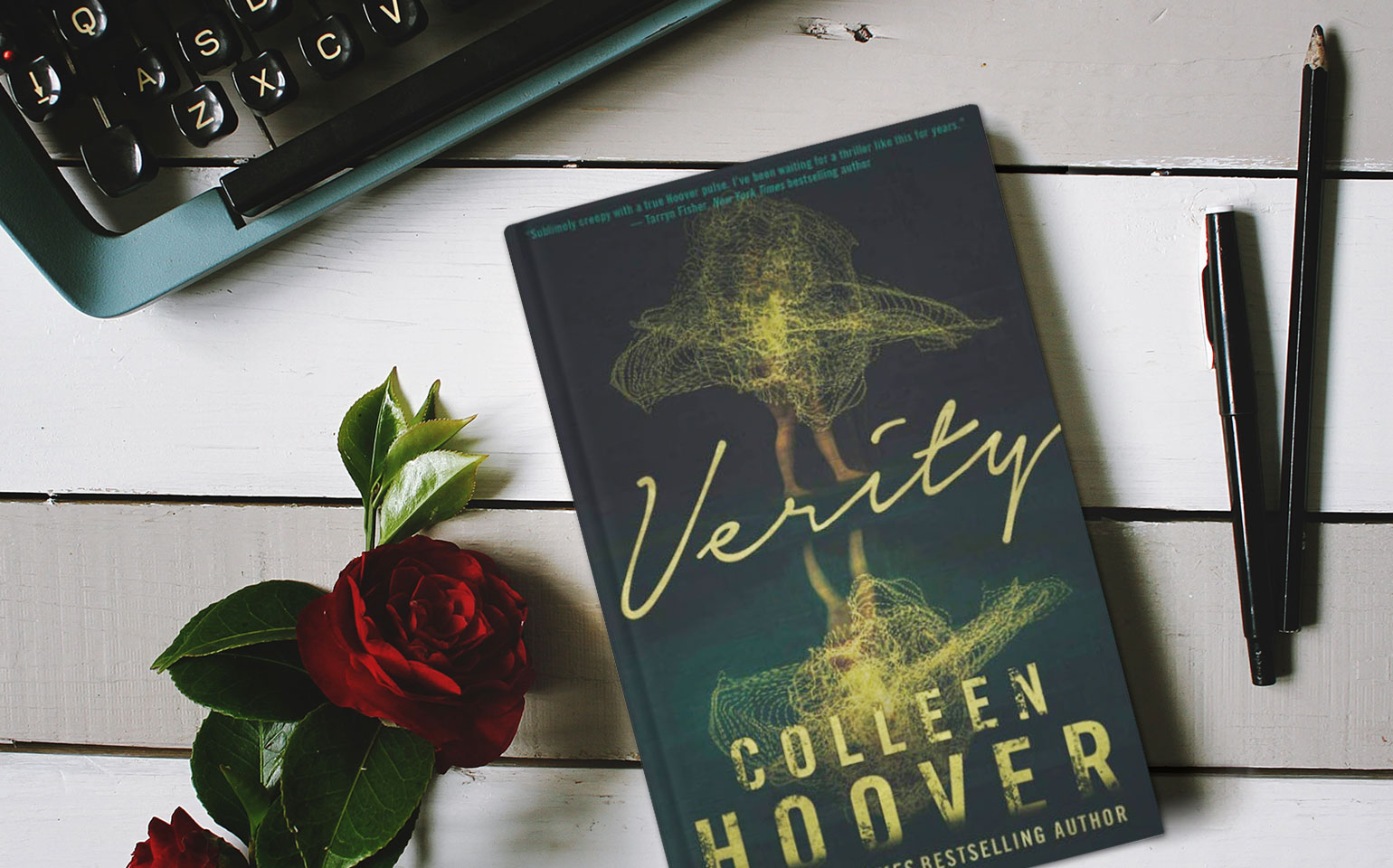 The cover of Colleen Hoover's Verity is shown, with a body being swallowed up by a golden cloud.