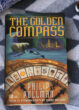 The cover of The Golden Compass is shown.