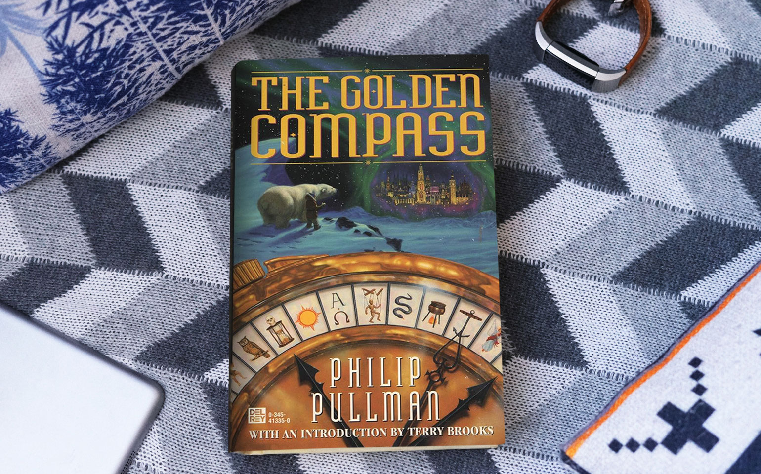 The cover of The Golden Compass is shown.