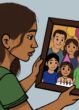 A woman looks at a picture of many people making up a family.